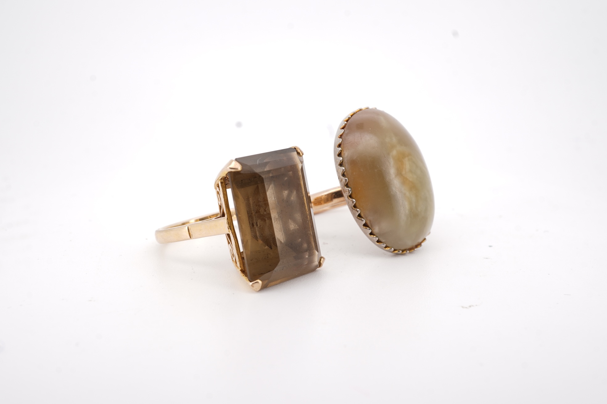 A modern 9ct gold and single stone emerald cut smoky quartz set ring, size N and one other 1960's 9ct gold shank, with a later added agate set white metal mount.